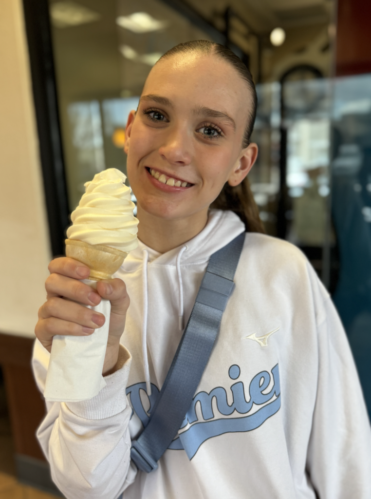 Teen girl enjoying a free birthday treats ice cream cone
